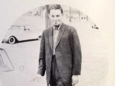 Harold Joe Waldrum and his light blue Peugot outside Lakin High School in the 1960s